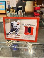 Front view of Henrik Sedin Bee Hive Matted Materials card on display stand