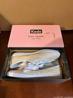 Sneakers in original box showing branding and contents