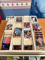 Open cardboard box showing two long rows of stacked NBA trading cards
