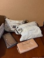 Group shot of two handbags and two wallets