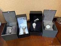 All four wristwatches in their original Bulova and TFX presentation boxes