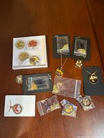 All nine resin flower necklaces displayed on tabletop including boxed set and bagged pieces