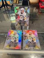 Front view of all three sleeved Sidney Crosby cards