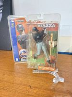 Front view of Mike Piazza action figure in unopened blister packaging with display stand