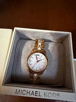 Watch in cushioned Michael Kors box showing dial and bracelet