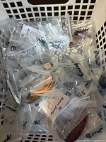 Basket containing many small zip bags holding earrings