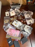 Overview of multiple bagged jewellery items on table