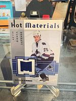 Front view of Fleer Hot Materials Kevin Bieksa jersey card in sleeve displaying jersey swatch