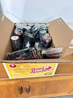 Cardboard box containing wrapped mini sticks and pucks