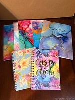 Seven sketchbooks/notebooks with assorted abstract and floral covers