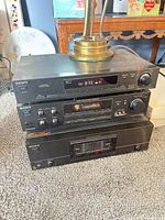 Stacked view of all three Sony components showing fronts and displays