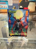 Front view of Spawn holographic card on stand