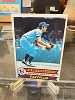 Front of Topps #330 George Brett baseball card on stand