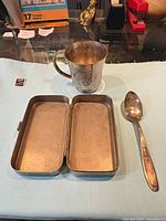 beaker, teaspoon and case displayed open
