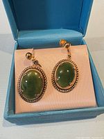 Pair of jade earrings in Birks box, close view