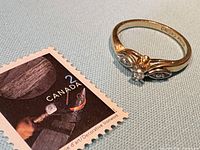 Ring beside Canadian 2¢ stamp showing scale