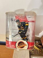 Front view of sealed Trevor Linden action figure in clamshell package