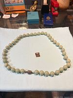Full view of bead necklace laid in oval