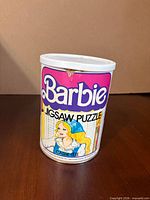 Front view of Barbie jigsaw puzzle canister