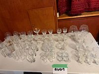 Tabletop view of entire assortment of clear glass pieces