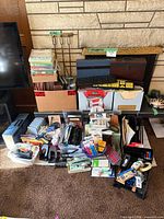 Overview of entire assortment spread on floor including paper goods, desk tools, filing supplies, keyboards