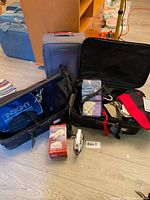 Overall view of both suitcases open with travel accessories displayed