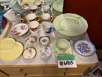 Group view showing plates, cups, saucers, mugs, pin dishes and vase on dresser