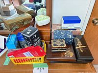 Group view of assorted jewelry boxes, cleaning supplies and ultrasonic cleaner
