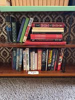 Two shelves filled with assorted hardcover and paperback books