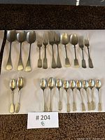 All 23 flatware pieces arranged on sheet