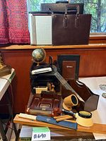 Group shot showing briefcases, letter tray, globe, desk accessories