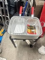 Overhead view of aluminum pot, two baskets, burner stand