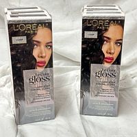 Front view two stacks of three sealed boxes of L’Oréal Paris Le Color Gloss Clear shade