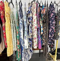 Full rack showing 15 assorted floral dresses