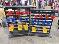 Front view of both metal parts racks with plastic bins attached