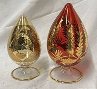 Front view of both glass egg ornaments showing color and gold etching