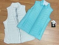 Both vests laid flat showing colors and quilt pattern