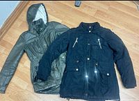 Both jackets laid flat, showing overall colors and styles