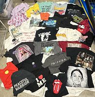 All 30 tee-shirts spread out showing graphics and colours