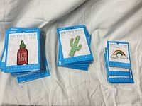 Three stacks of sealed Retro Pop patch packages: Hot Stuff, cactus, rainbow