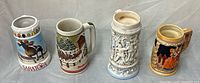 Front view of all four steins side by side