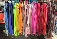 Front view of rack holding multiple colored women’s hoodies