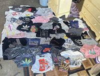 Overhead view of all 50 T-shirts spread out showing variety