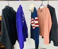 Five assorted jackets hanging on rack