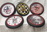 Group shot of five CAMY wall clocks showing all designs