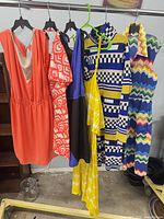 All six dresses hanging on rack