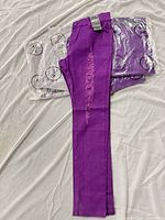 Six purple distressed jeans, one pair displayed, five pair bagged