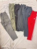 All seven pants laid out side-by-side showing colours and overall condition