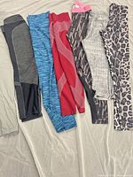 All seven pairs of assorted women’s workout leggings laid flat showing colors and patterns