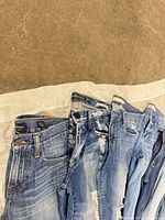 Waistbands and front detail of five jean pairs